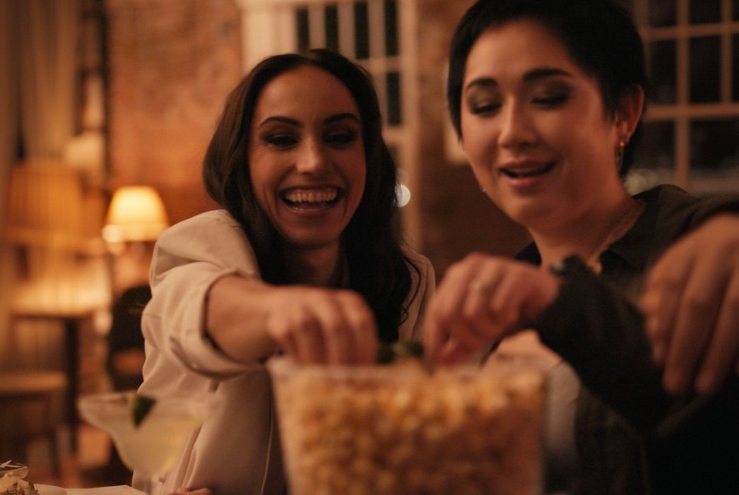 Friends sharing a bowl of popcorn