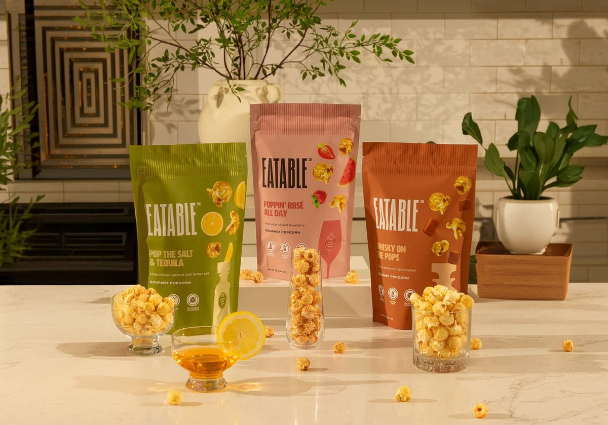 The three EATABLE fall flavours on a kitchen counter with bowls of popcorn